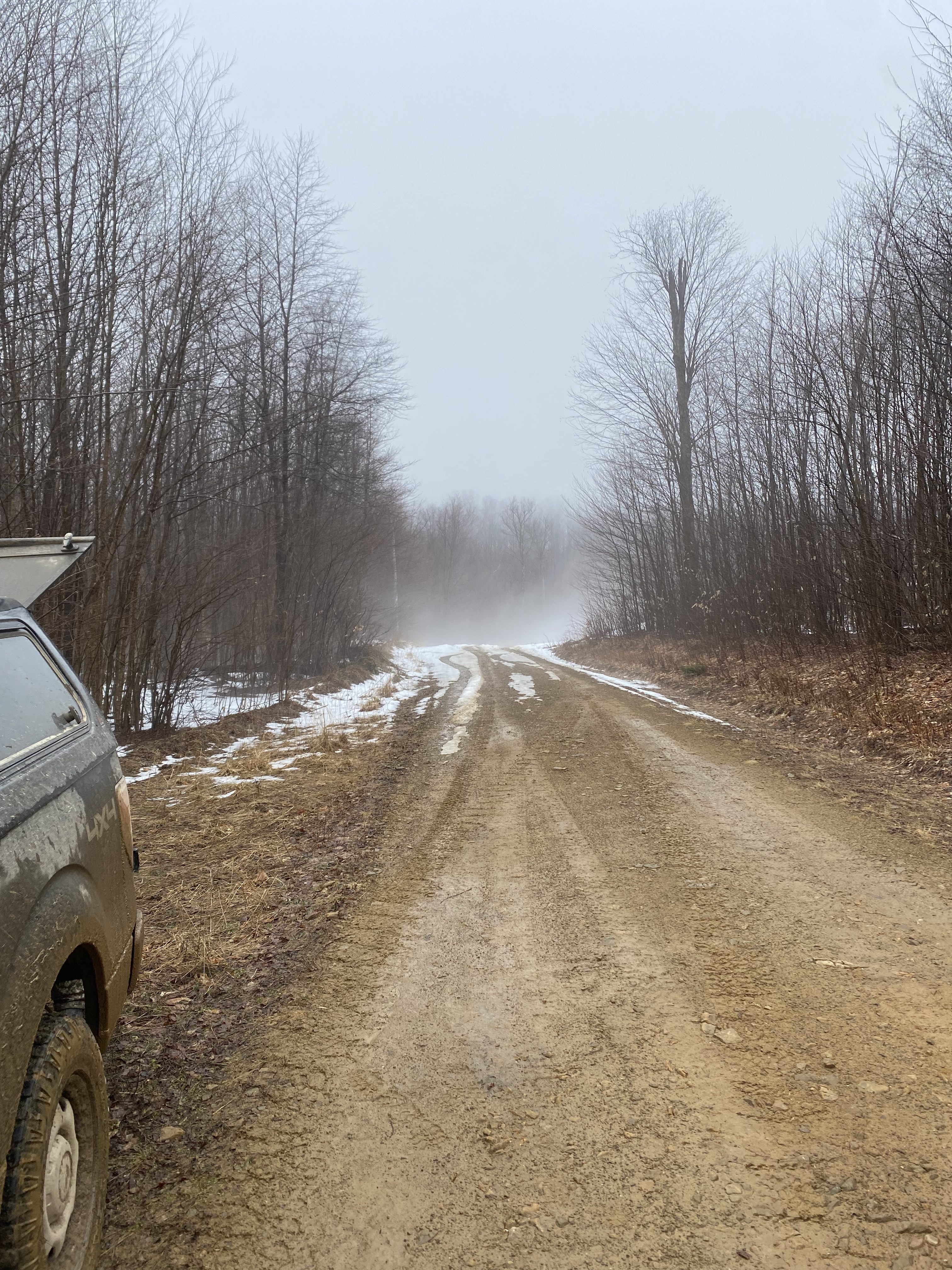Dirt road with snow fog in the distance