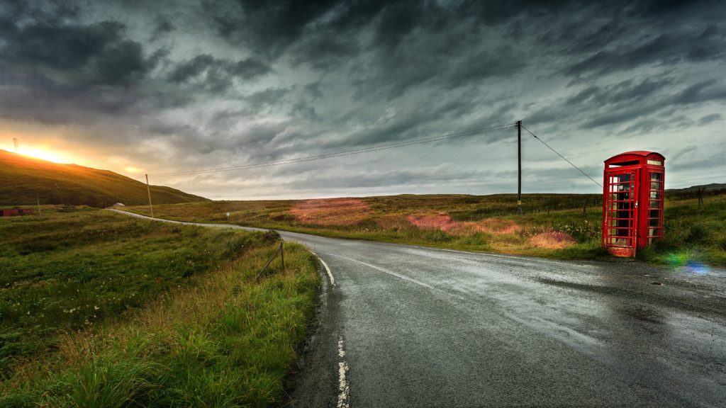 phone booth along country road during sunset